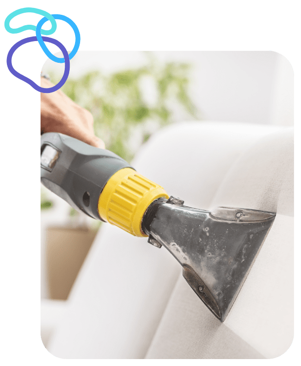 Professional upholstery cleaning in Duval County – technician deep cleaning a sectional couch with steam equipment